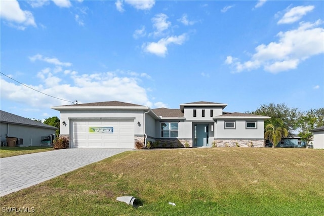 view of front of house featuring a garage and a front lawn