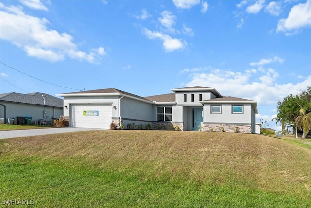 view of front of home featuring a garage and a front lawn