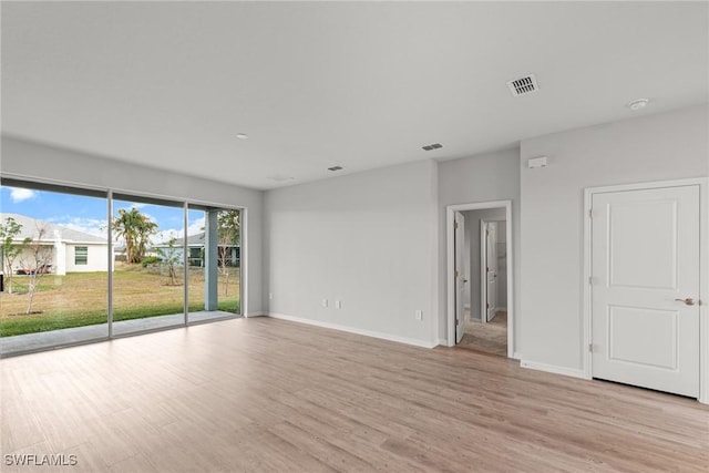 empty room with light hardwood / wood-style flooring