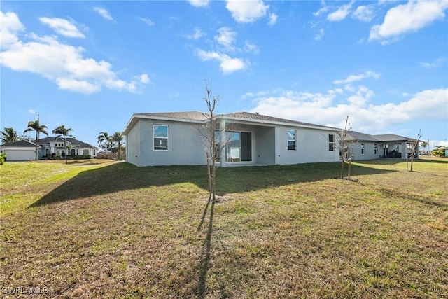 rear view of house featuring a yard