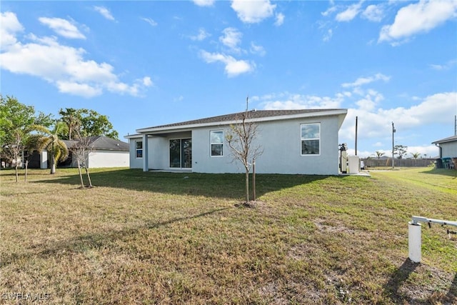 back of house with a yard