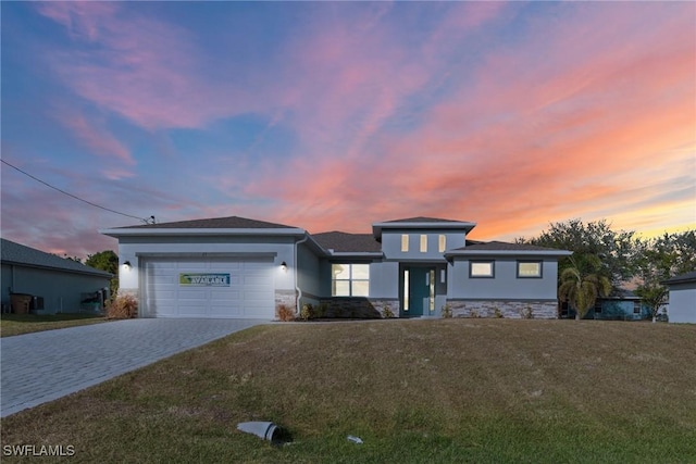 view of front of property with a yard and a garage