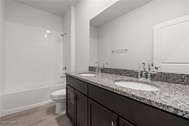 full bathroom with vanity, wood-type flooring, tub / shower combination, and toilet