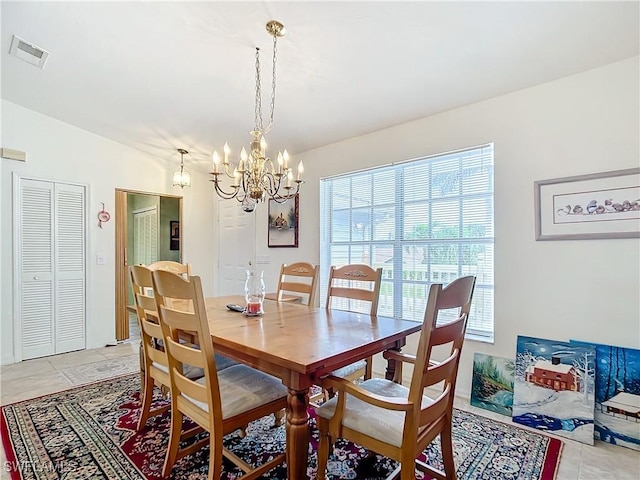 7397 Grande Pine Rd, Bokeelia, FL 33922 - tiled dining area with vaulted ceiling and a chandelier