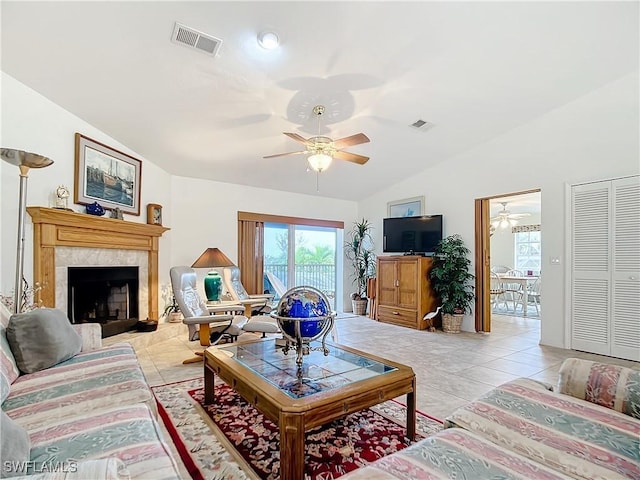 7397 Grande Pine Rd, Bokeelia, FL 33922 - tiled living room with ceiling fan, lofted ceiling, and a tiled fireplace