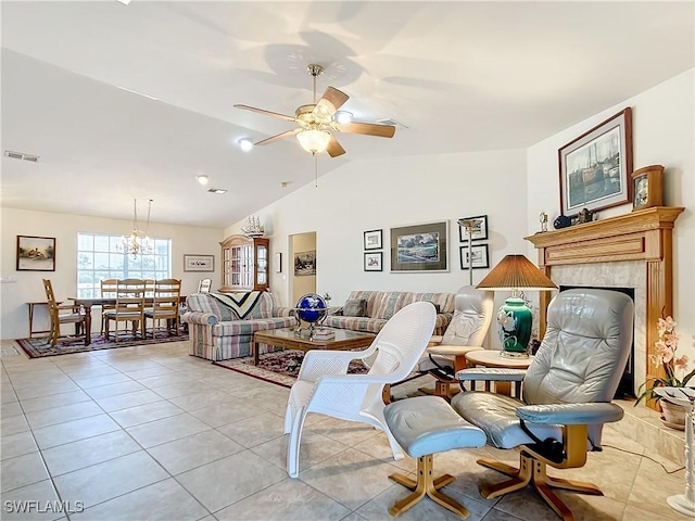7397 Grande Pine Rd, Bokeelia, FL 33922 - living room with light tile patterned floors, ceiling fan with notable chandelier, vaulted ceiling, and a premium fireplace