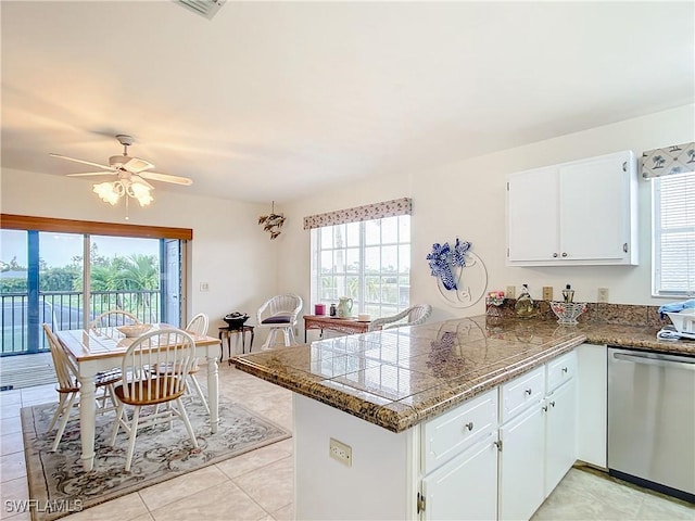 7397 Grande Pine Rd, Bokeelia, FL 33922 - kitchen featuring kitchen peninsula, white cabinets, stainless steel dishwasher, and a wealth of natural light