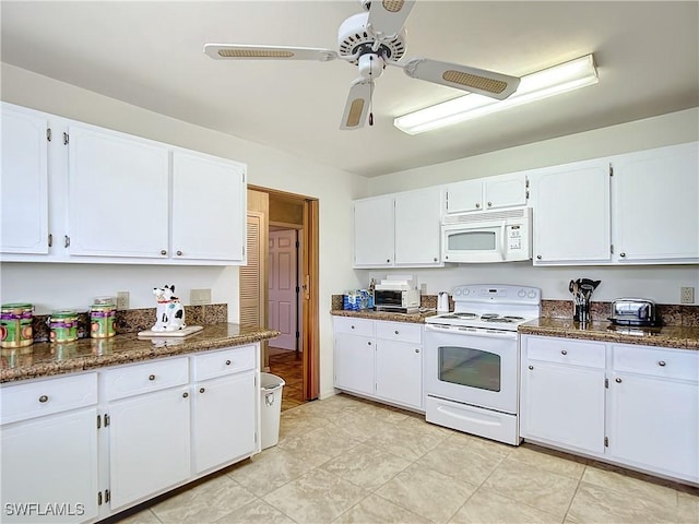 7397 Grande Pine Rd, Bokeelia, FL 33922 - kitchen featuring white appliances, white cabinetry, ceiling fan, and dark stone countertops
