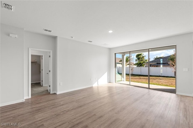 spare room with hardwood / wood-style floors