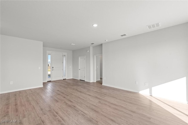 unfurnished living room with light wood-type flooring