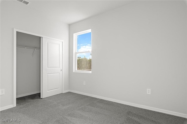 unfurnished bedroom featuring carpet flooring and a closet