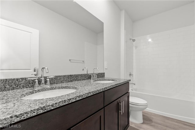 full bathroom featuring vanity, toilet, wood-type flooring, and shower / tub combination