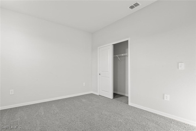 unfurnished bedroom with carpet and a closet