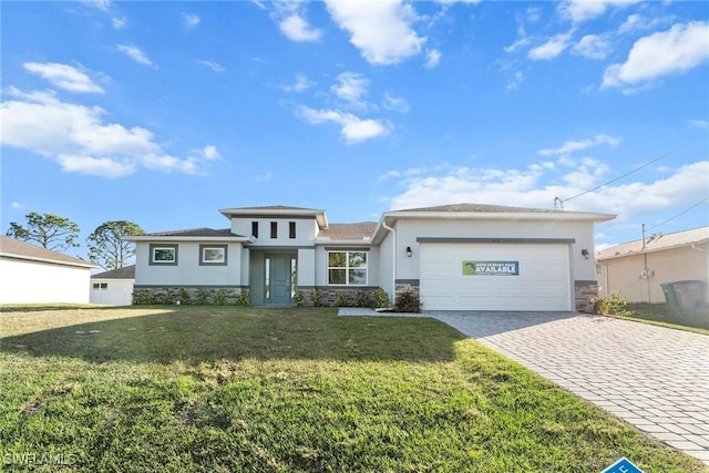 prairie-style home with a front lawn and a garage