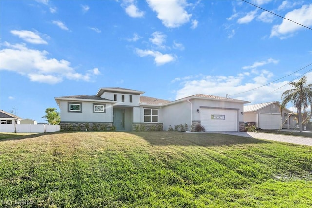 view of front of property featuring a garage and a front lawn