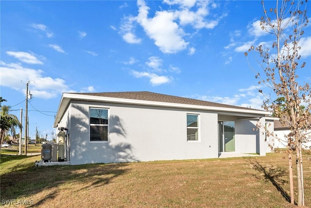 rear view of property with a lawn