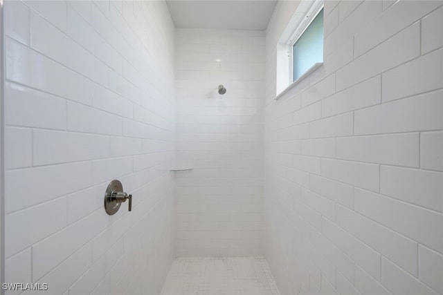 bathroom with tiled shower