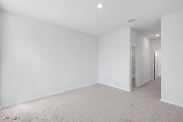 unfurnished room with light colored carpet