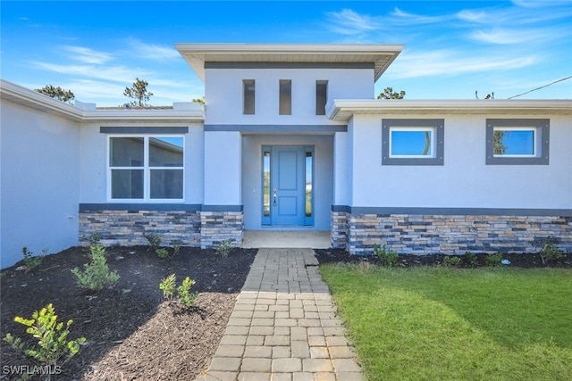 entrance to property with a yard