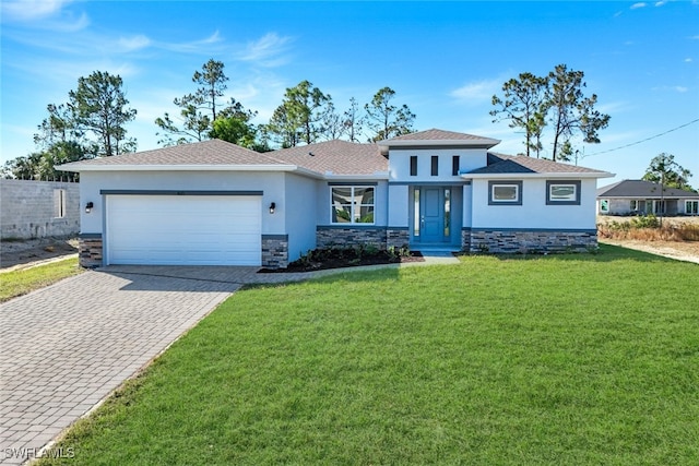 view of front of property with a garage and a front lawn