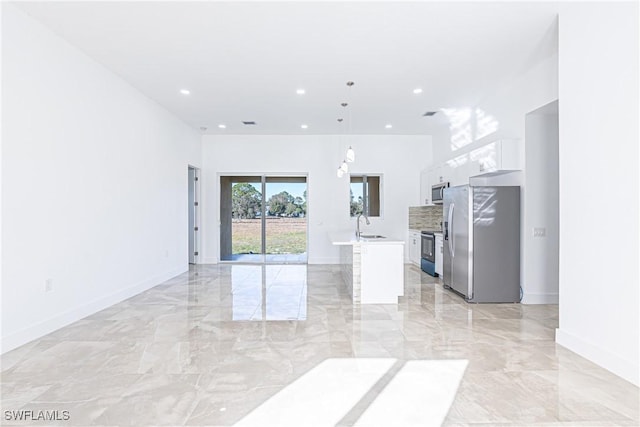 interior space featuring marble finish floor, recessed lighting, a sink, and baseboards