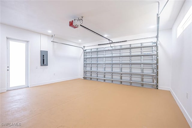 garage featuring a garage door opener, electric panel, and baseboards