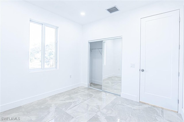 unfurnished bedroom with recessed lighting, a closet, visible vents, and baseboards