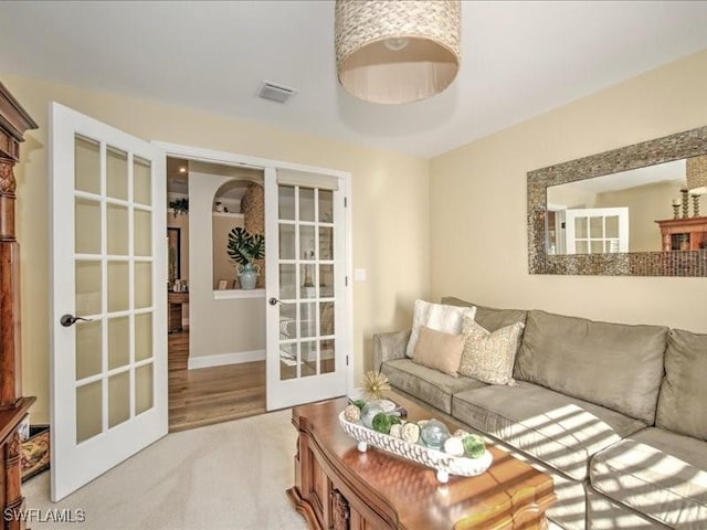 carpeted living room featuring french doors