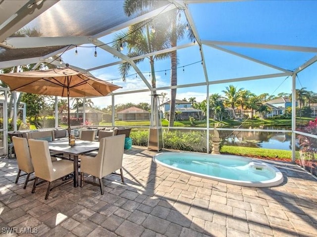 view of patio featuring glass enclosure, a water view, and a swimming pool