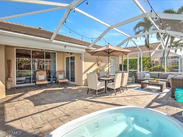 view of pool with glass enclosure, a patio area, a hot tub, and an outdoor hangout area