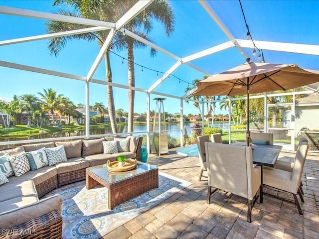 view of patio / terrace with outdoor lounge area, a water view, and a lanai