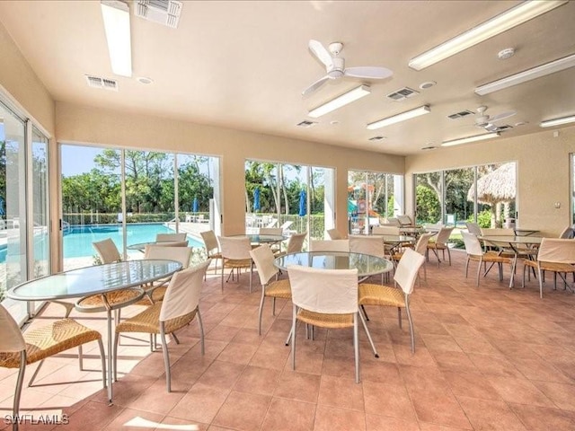 dining area featuring ceiling fan and light tile patterned flooring