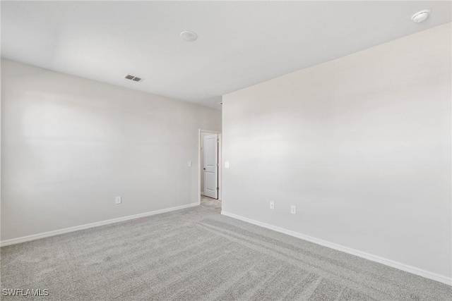 unfurnished room featuring light colored carpet