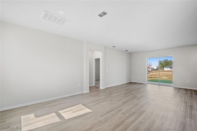 empty room with light hardwood / wood-style flooring