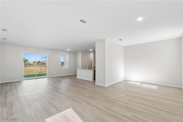 unfurnished living room with light hardwood / wood-style floors