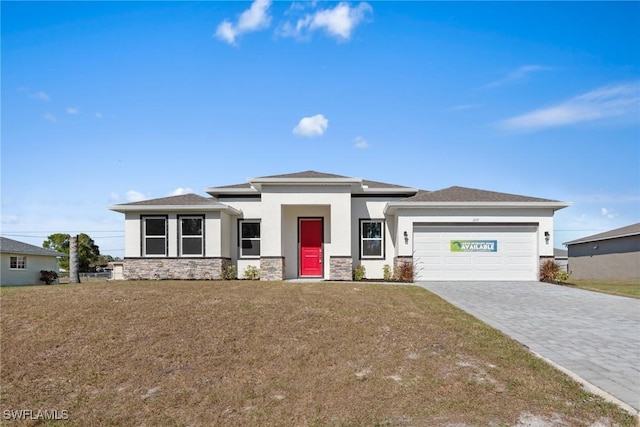 prairie-style home with a front yard and a garage