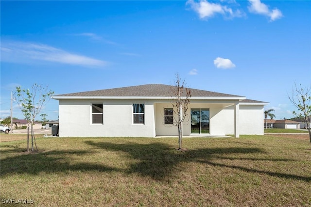 rear view of house featuring a yard