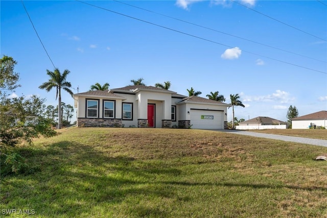 view of front of house featuring a front yard and a garage