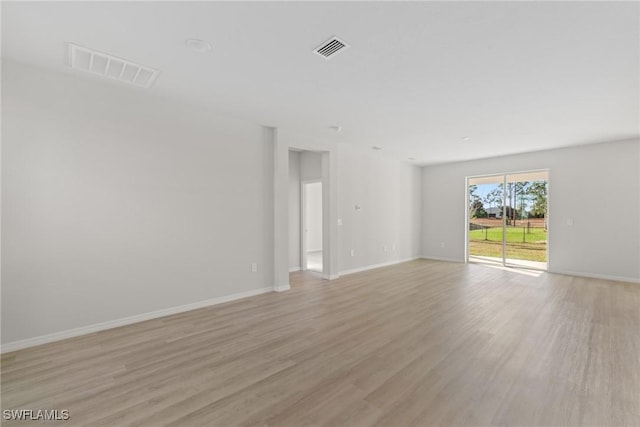 spare room with light hardwood / wood-style flooring