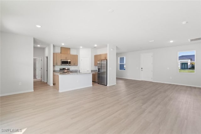 unfurnished living room featuring light wood-type flooring