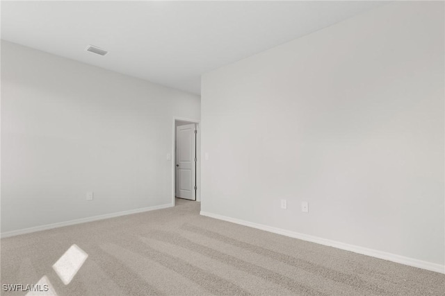 spare room with light carpet