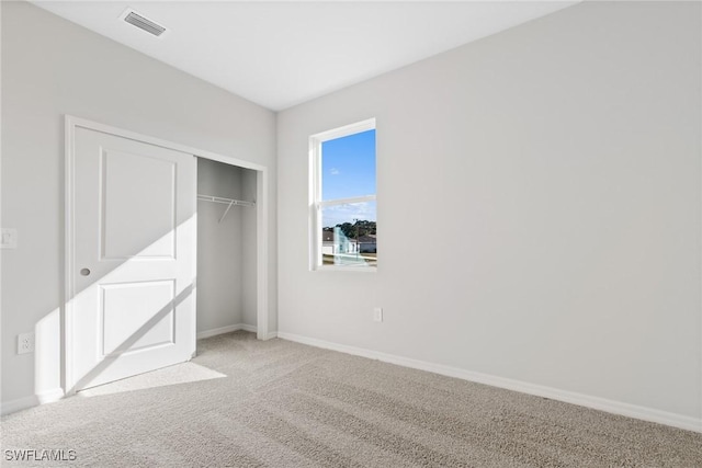 unfurnished bedroom with carpet floors and a closet