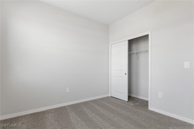 unfurnished bedroom with a closet and carpet floors