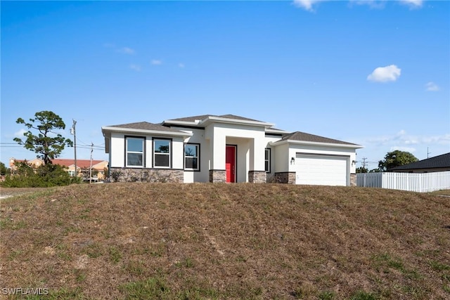 view of front of home with a garage and a front lawn