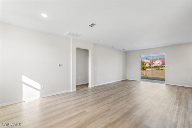 empty room with light hardwood / wood-style flooring