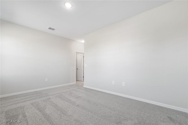 unfurnished room featuring light colored carpet