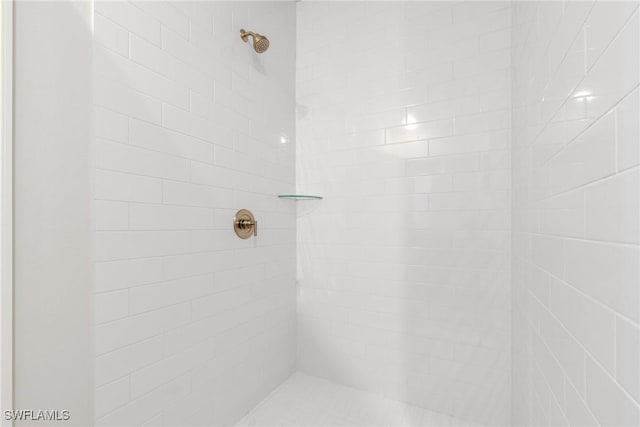 bathroom with a tile shower