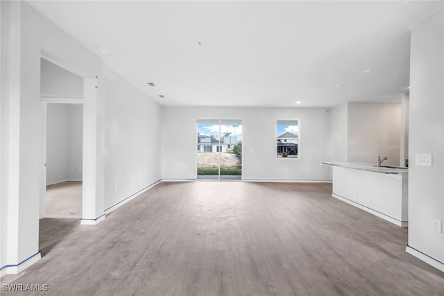 unfurnished living room featuring hardwood / wood-style flooring