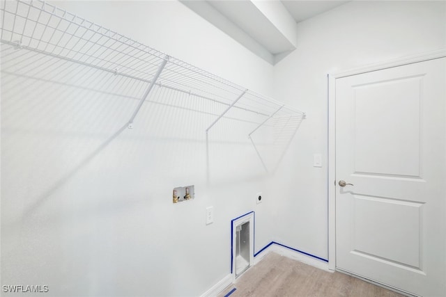 laundry area featuring washer hookup, light hardwood / wood-style floors, and hookup for an electric dryer