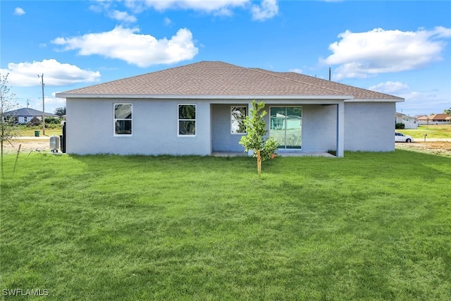 rear view of property featuring a yard